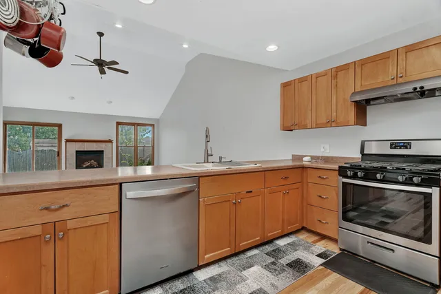 a kitchen with stainless steel appliances granite countertop a sink and cabinets