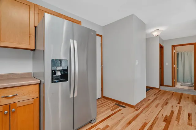 a view of a kitchen with refrigerator and cabinet