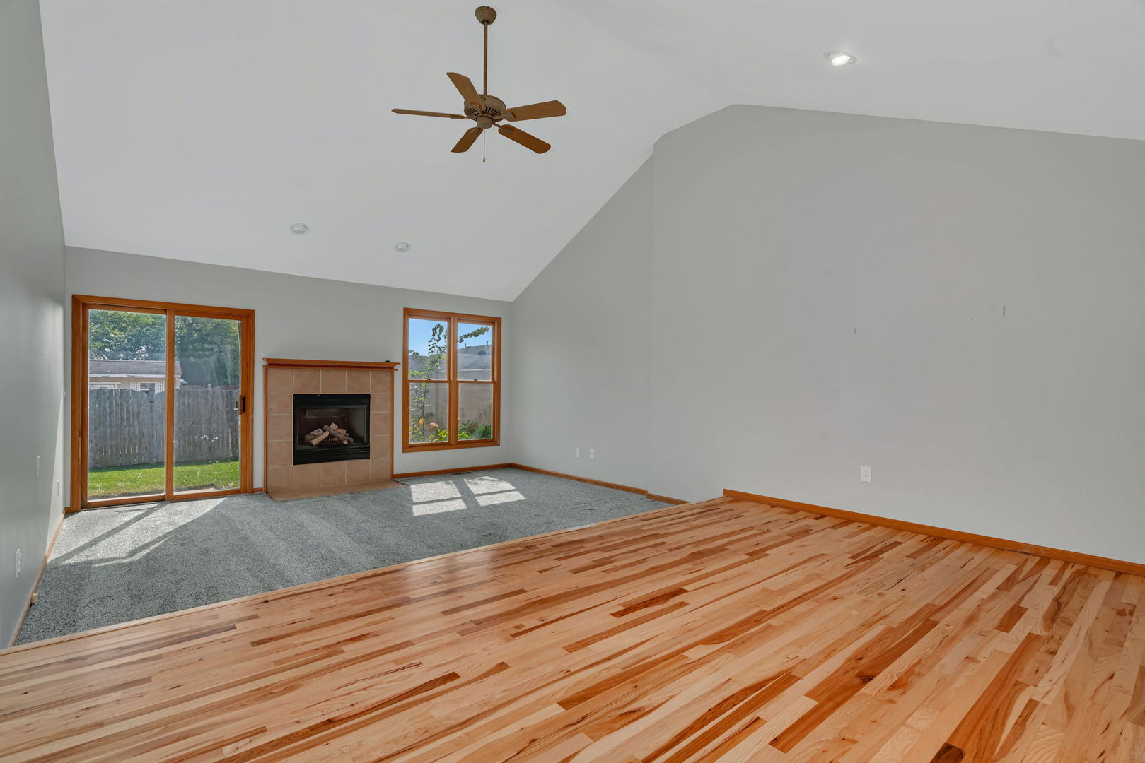 210 Kevin Drive Diamond, IL 60416 - Photo 7 of 23 a view of empty room with wooden floor and fireplace