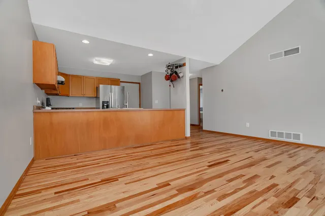a view of a room with wooden floor and cabinet