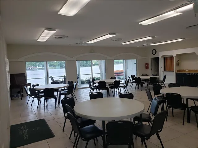 a view of a swimming pool and lounge chairs in back yard of the house
