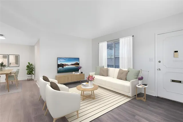 a living room with furniture a rug and a window