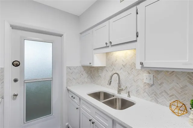 a kitchen with a sink and cabinets