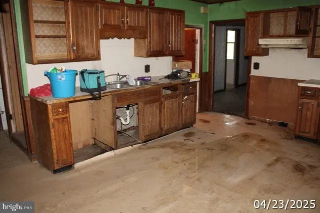a kitchen with stainless steel appliances granite countertop a refrigerator and sink