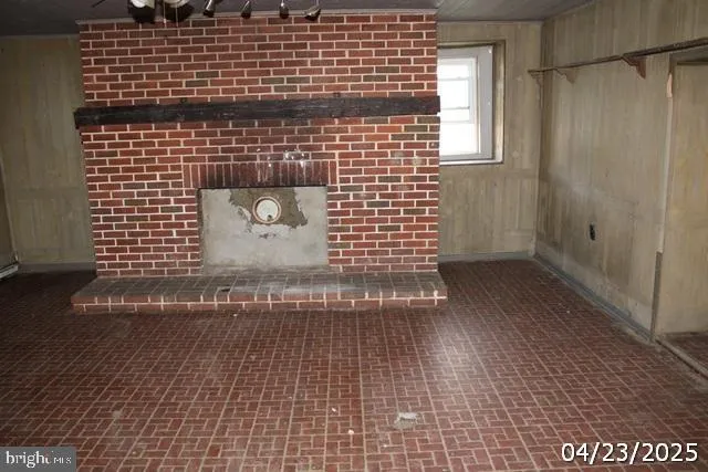 a view of empty room with fireplace