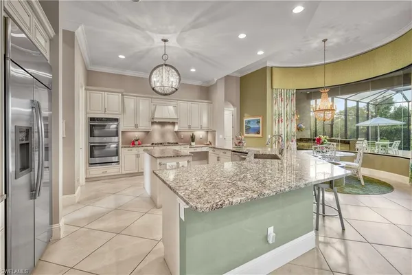 a kitchen with stainless steel appliances granite countertop a sink and a stove