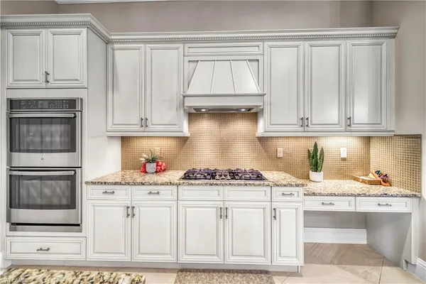 a kitchen with stainless steel appliances granite countertop a stove and cabinets