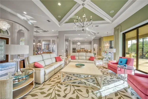 a living room with fireplace furniture and a chandelier