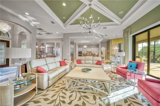 a living room with fireplace furniture and a chandelier