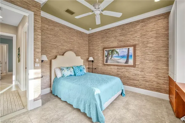 a bedroom with a bed and a wall painting