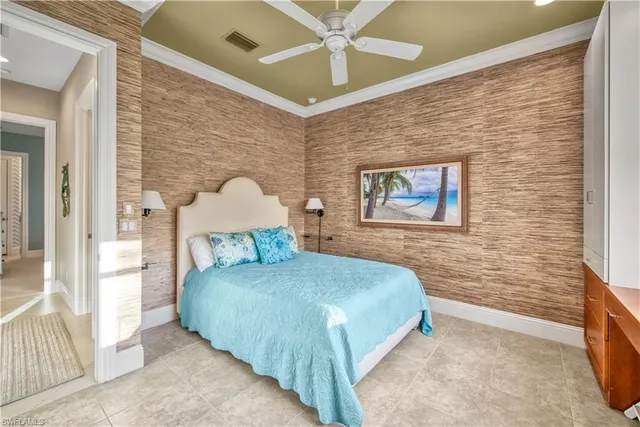 a bedroom with a bed and a wall painting