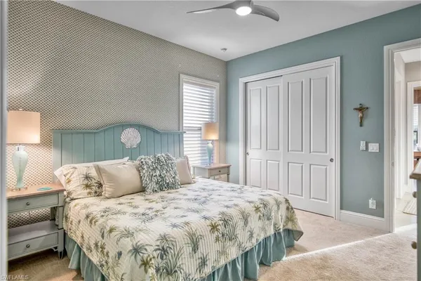 a bedroom with a bed and a lamp