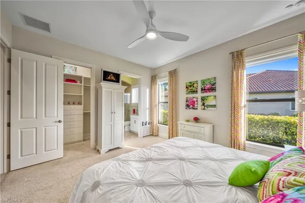 a bedroom with a bed dresser and a window