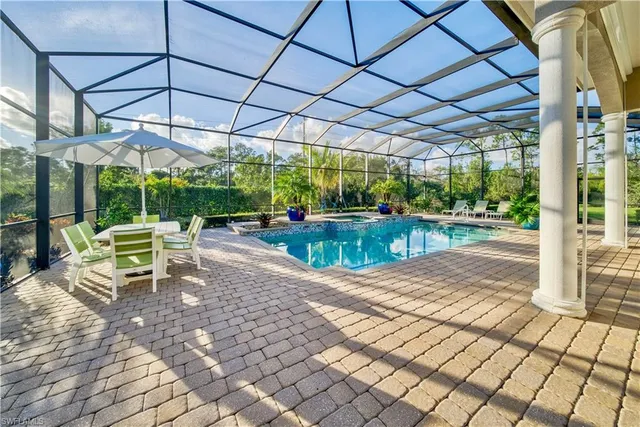 a view of a patio with a table and chairs under an umbrella