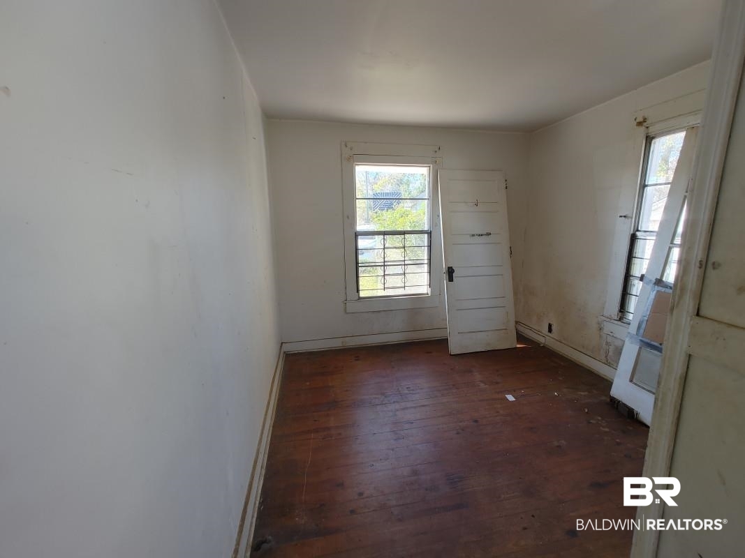 1706 Lomeroy Street Mobile, AL 36604 - Photo 18 of 24 Spare room featuring dark wood finished floors and baseboards