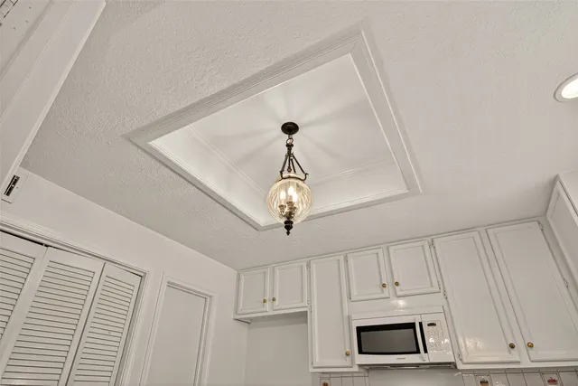 a kitchen with white cabinets stainless steel appliances and sink