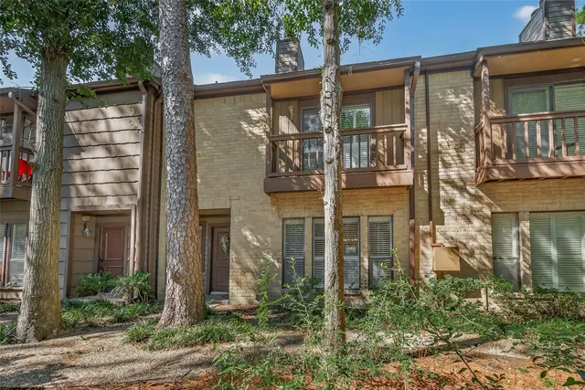 front view of a brick house with a small yard