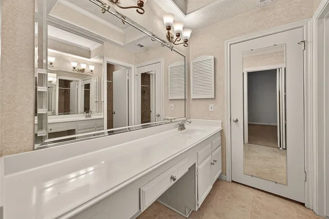 a spacious bathroom with a granite countertop sink mirror and vanity