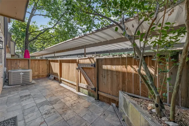 a view of backyard with wooden fence