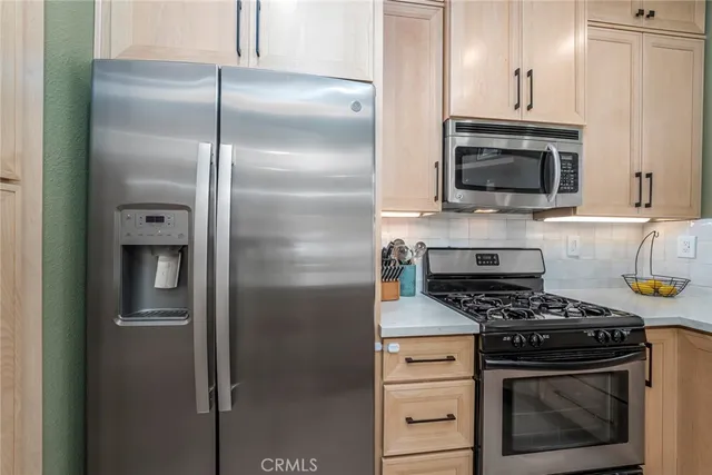 a kitchen with cabinets and stainless steel appliances