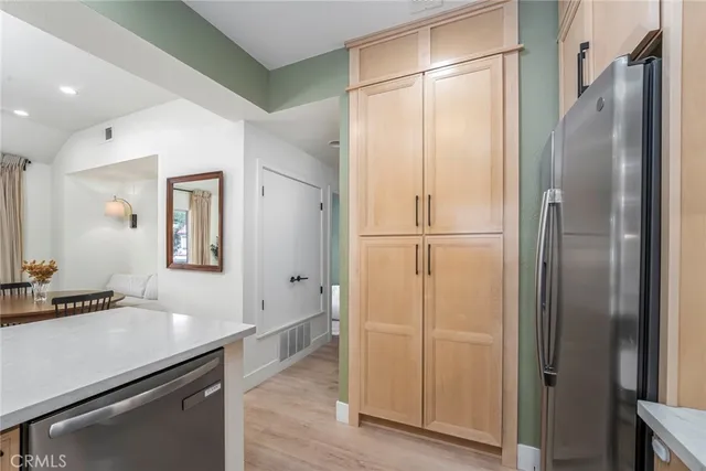 a kitchen with stainless steel appliances a refrigerator and cabinets