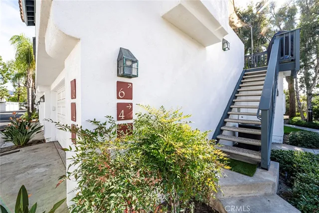 a view of a garden with flowers and wooden fence