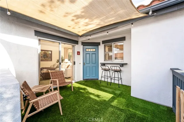 a view of two chairs in the backyard