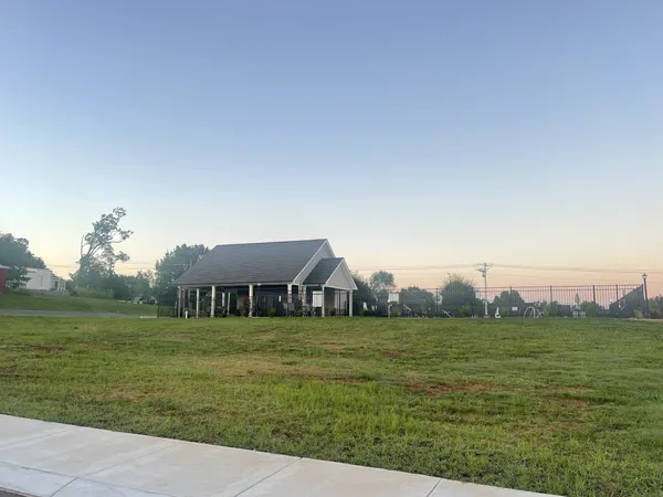 a view of a field with grass and a fence