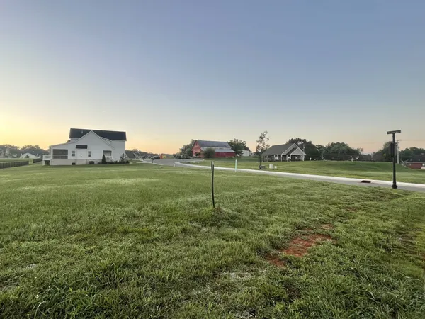 a view of a house with a yard and garage
