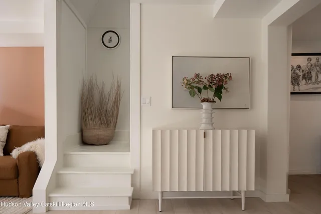 a view of a hallway with a couch and a large window