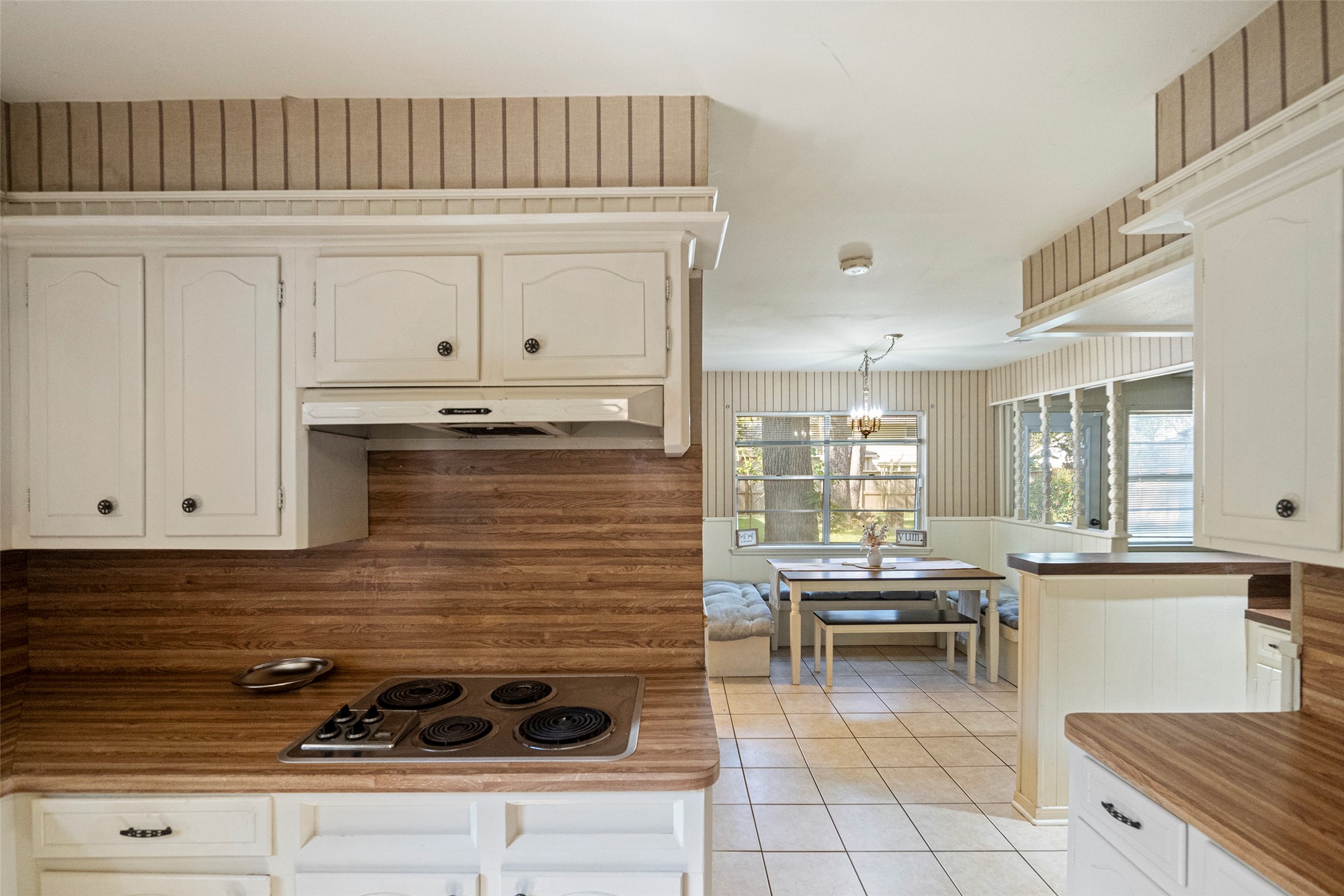 1115 Pear Tree Lane Houston, TX 77073 - Photo 12 of 30 a kitchen with a stove and white cabinets