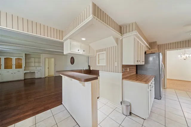 a view of empty room with wooden floor and fireplace