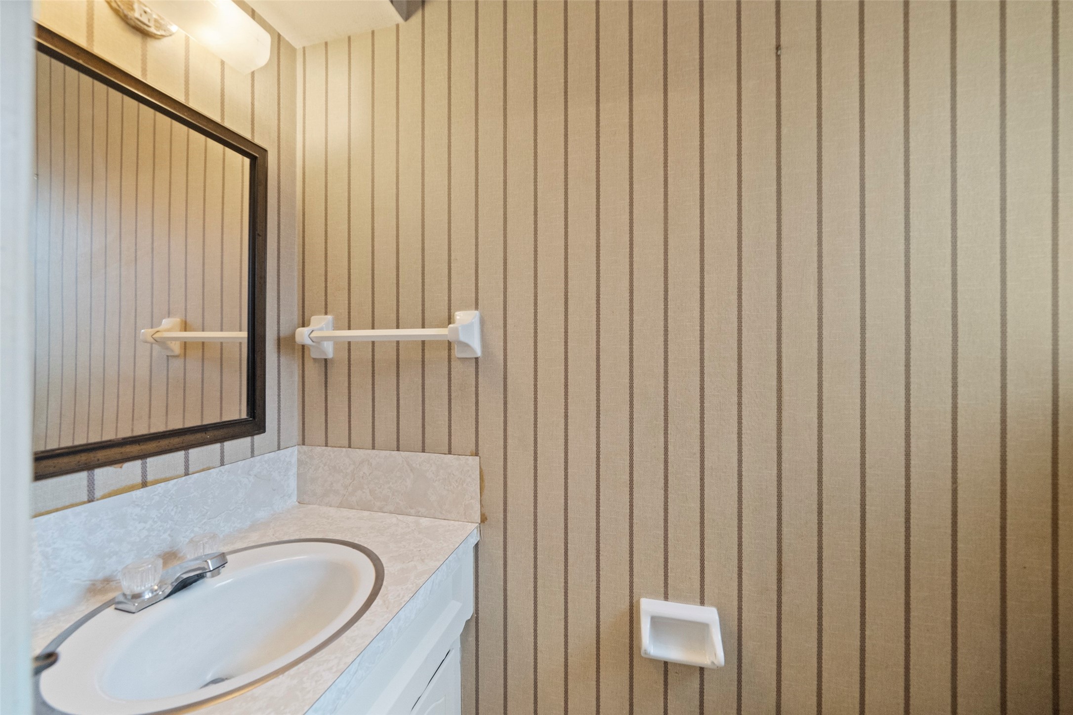 1115 Pear Tree Lane Houston, TX 77073 - Photo 23 of 30 a bathroom with a sink and a mirror