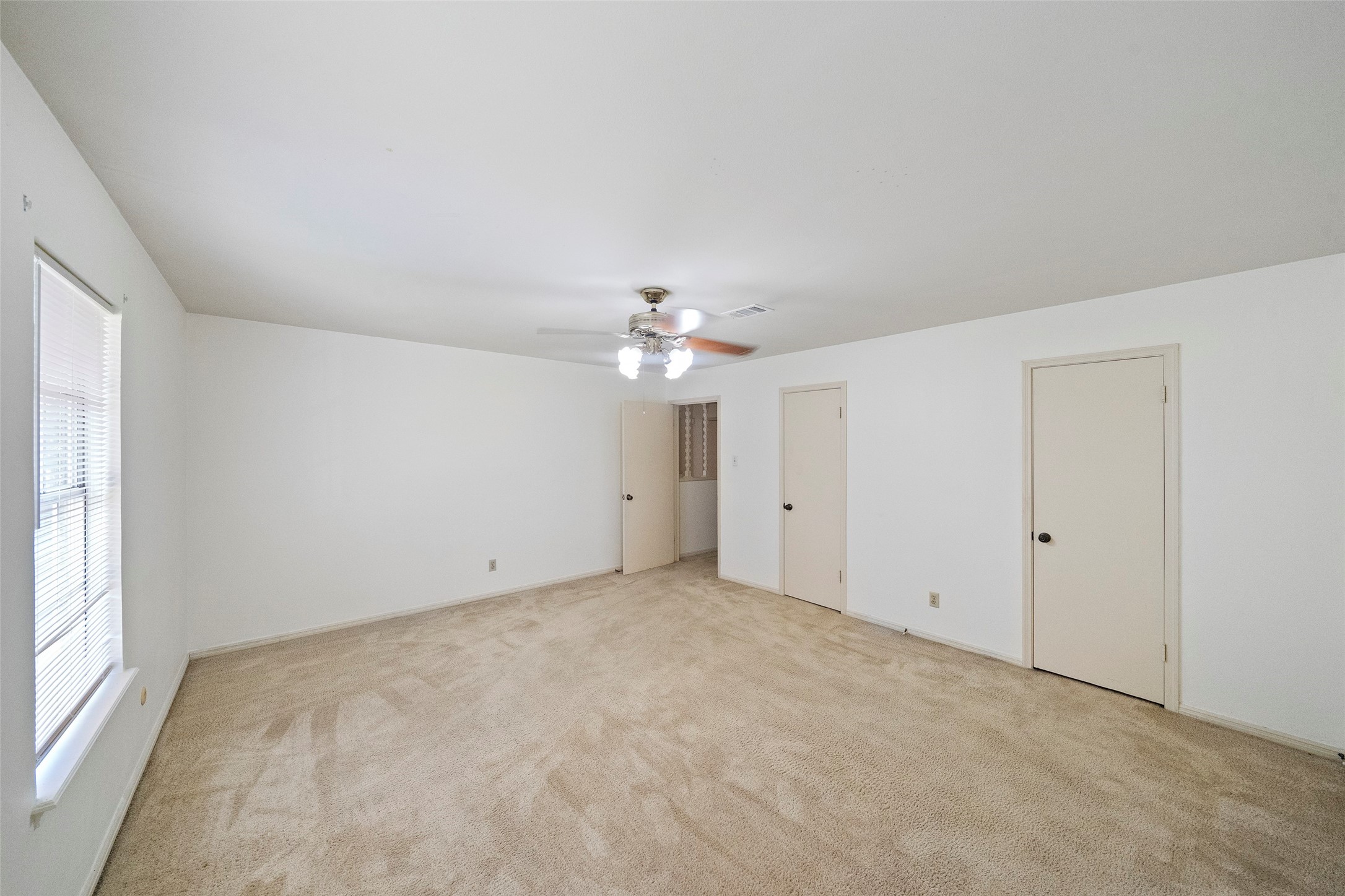 1115 Pear Tree Lane Houston, TX 77073 - Photo 26 of 30 an empty room with a window and a ceiling fan