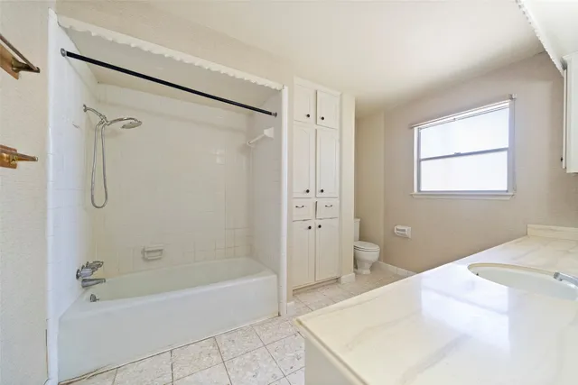 a view of a house with backyard and a tree