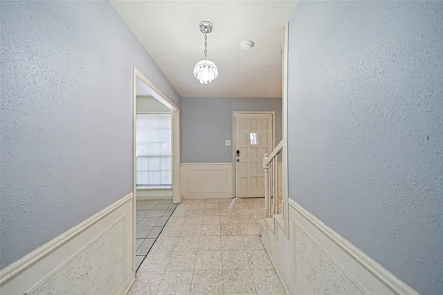 an empty room with windows and entrance