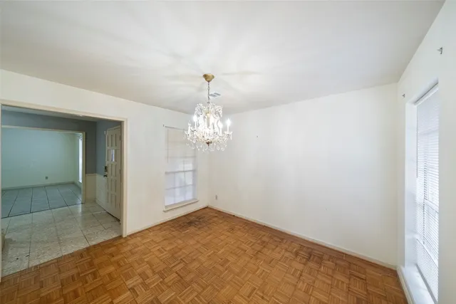 a view of a chandelier in big room and chandelier