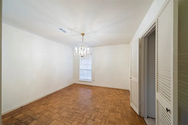 a view of an empty room with a chandelier