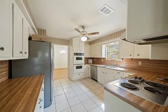 a kitchen with a sink appliances and cabinets