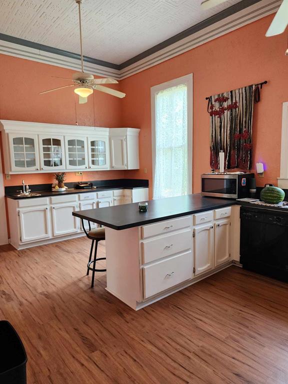 205 South 2nd Street Logansport, LA 71049 - Photo 17 of 36 a kitchen with stainless steel appliances granite countertop a stove a sink dishwasher and a microwave oven with cabinets
