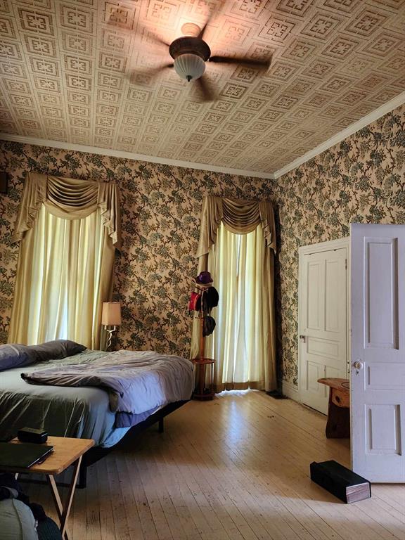 205 South 2nd Street Logansport, LA 71049 - Photo 19 of 36 a bedroom with a bed and wooden floor