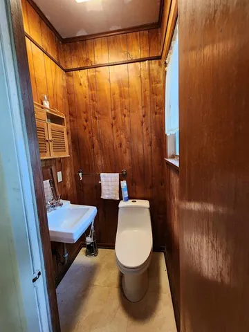 a bathroom with a sink a toilet a mirror and shower