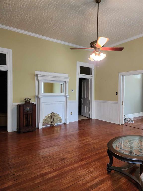 205 South 2nd Street Logansport, LA 71049 - Photo 25 of 36 a view of a livingroom with a fireplace a ceiling fan and wooden floor