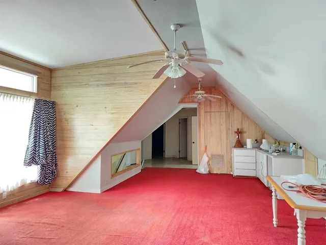 a view of a livingroom with furniture and staircase