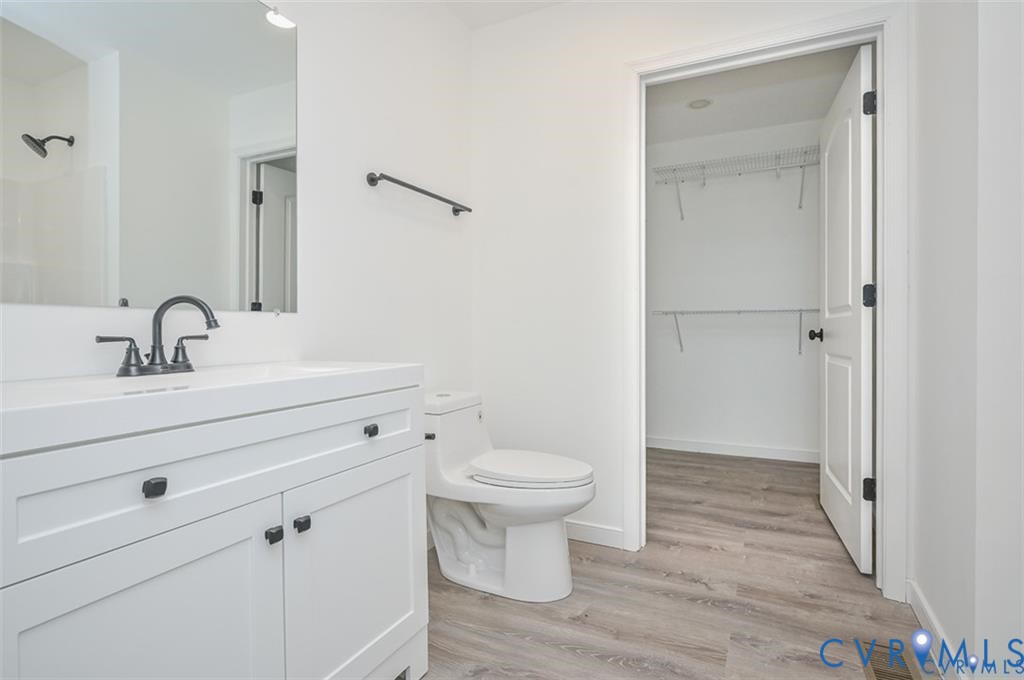 26471 Slash Pine Circle Ruther Glen, VA 22546 - Photo 16 of 36 a bathroom with a toilet sink and a mirror
