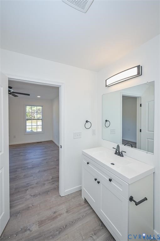 26471 Slash Pine Circle Ruther Glen, VA 22546 - Photo 18 of 36 a bathroom with a sink mirror and vanity