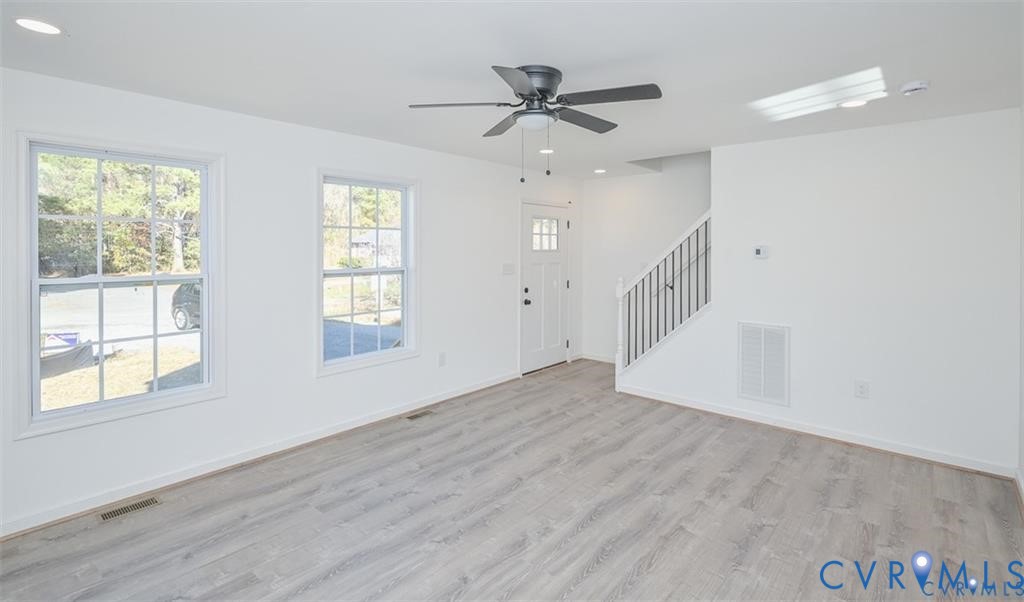 26471 Slash Pine Circle Ruther Glen, VA 22546 - Photo 3 of 36 a view of an empty room with wooden floor and a window
