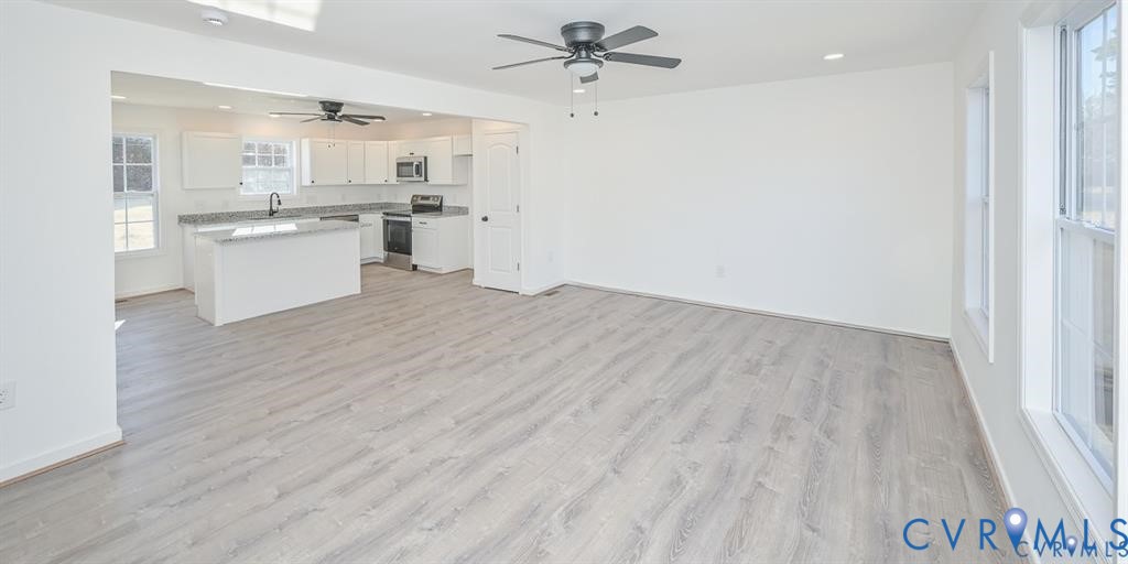 26471 Slash Pine Circle Ruther Glen, VA 22546 - Photo 6 of 36 a view of a kitchen with wooden floor and a kitchen