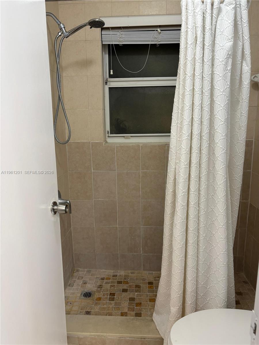 2907 Southeast 15th Terrace Homestead, FL 33035 - Photo 20 of 30 a bathroom with a shower and a mirror