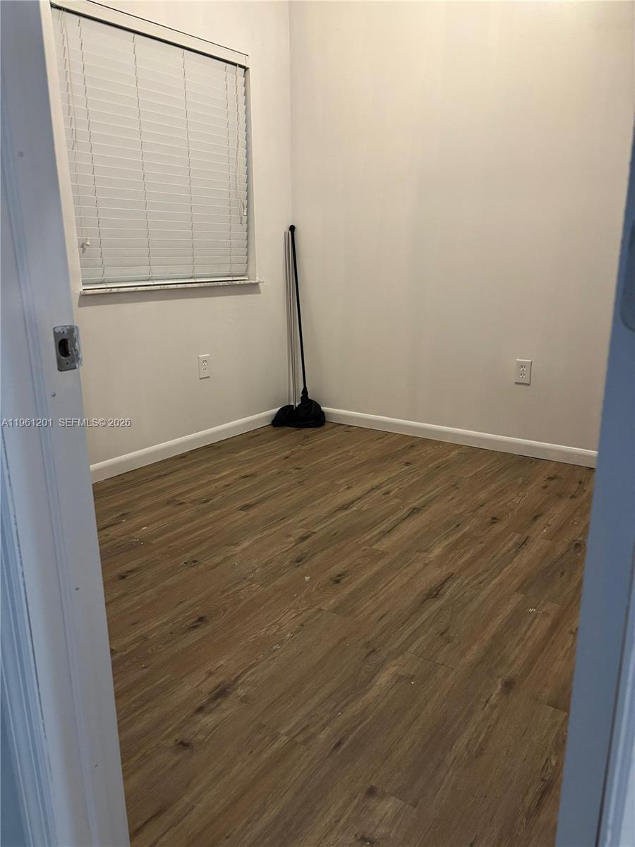 2907 Southeast 15th Terrace Homestead, FL 33035 - Photo 9 of 30 a view of a room with wooden floor and white wall